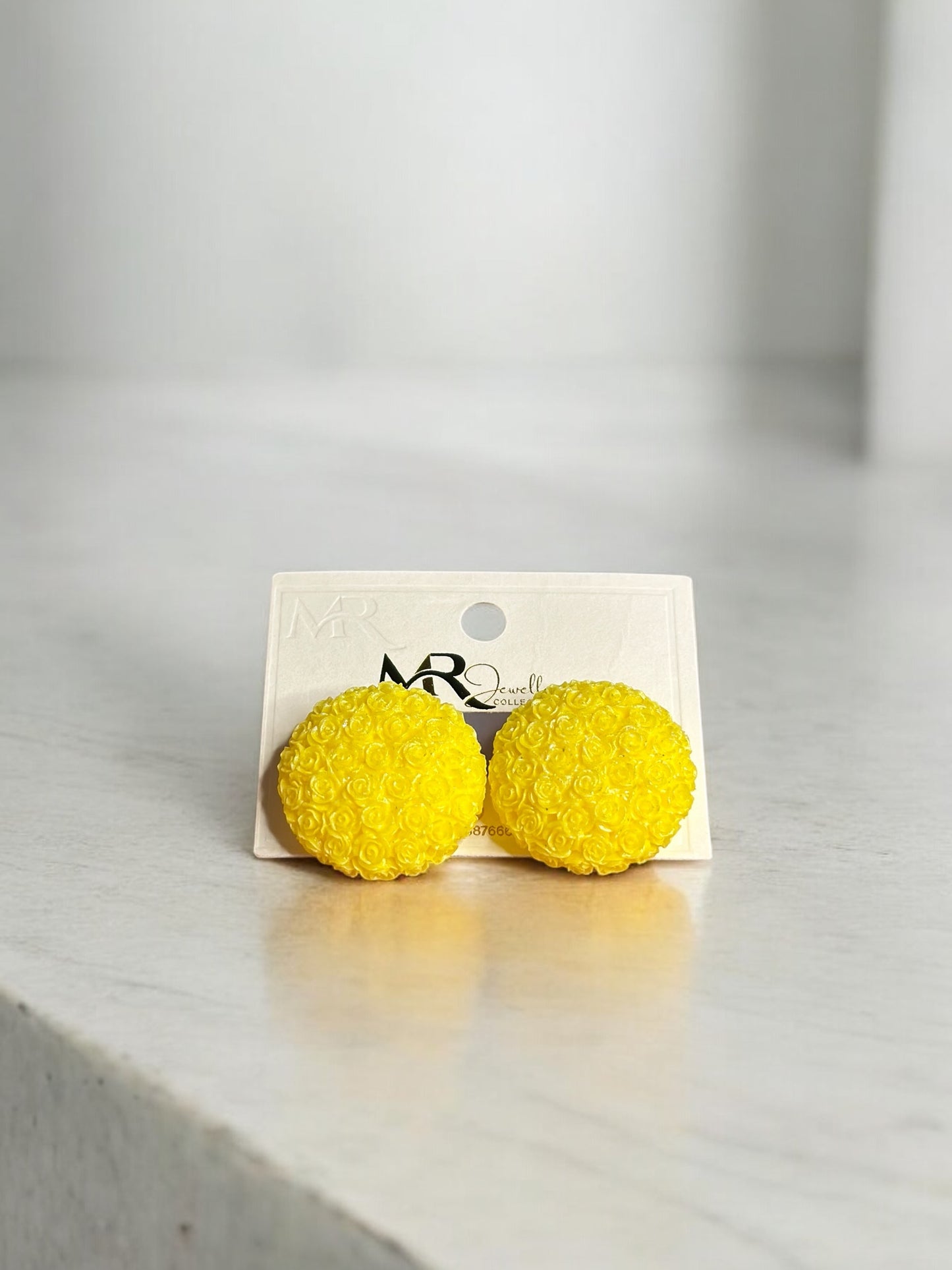 yellow floral studs with intricate detailing for a cheerful