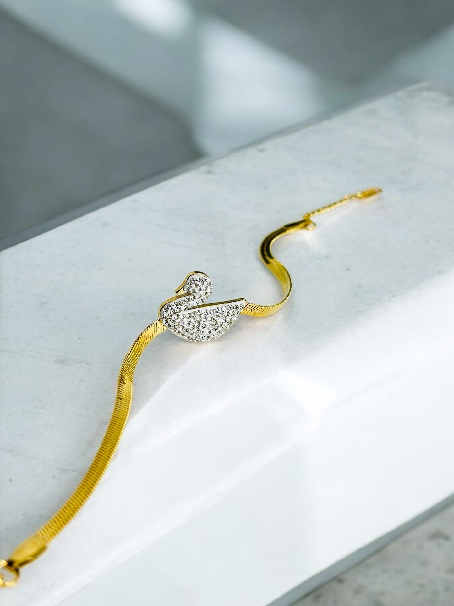 Swan-Inspired Bracelet with Gold Chain and Crystal Detailing